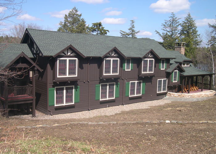 green-shutters-dark-wood-siding